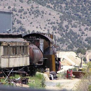 Rusting locomotive, passenger car and caboose