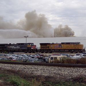 UP 5562 passes a raging warehouse fire