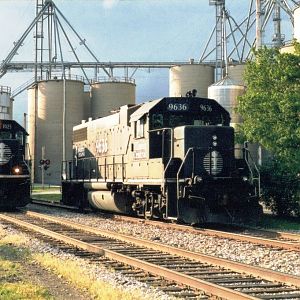 IC 96 waits for a loaded grain train to clear