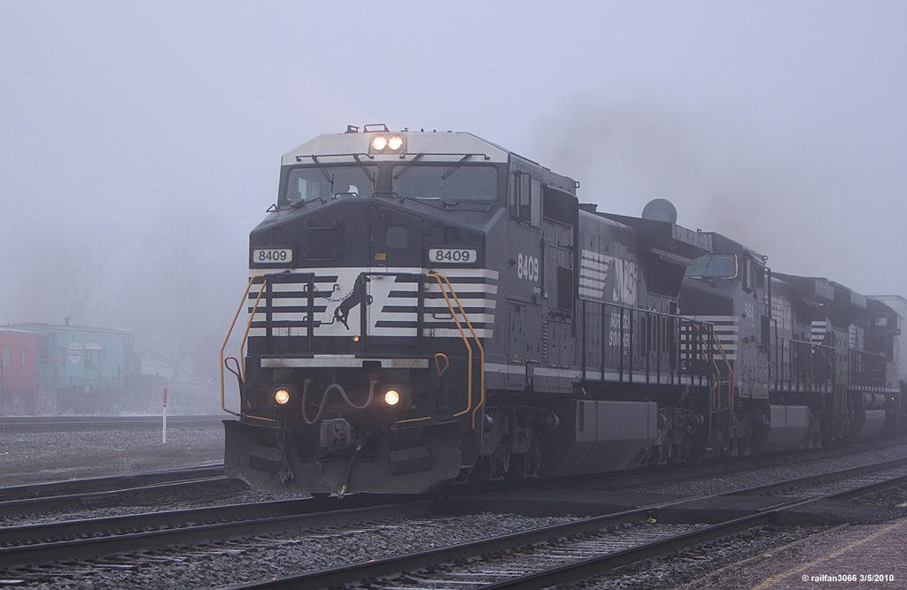 Still in the fog NS 8409 heads east passed the depot in Elkhart