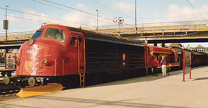 Excursion train leaving mainline station.