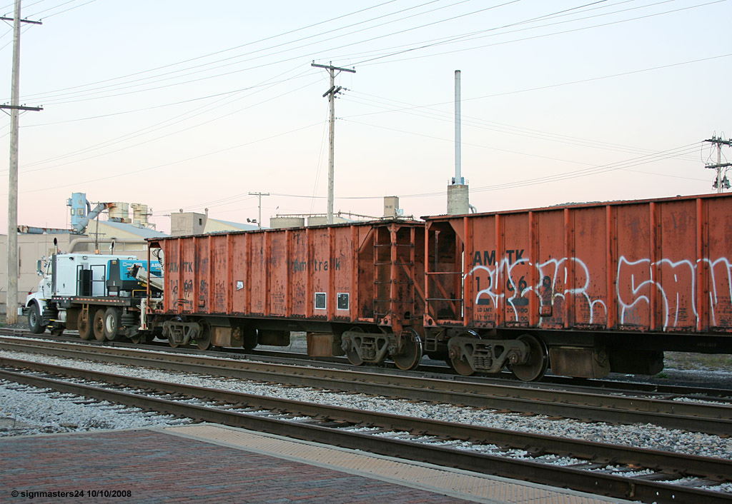 Highrailer parked with Amtrak stone cars Dowagiac, MI