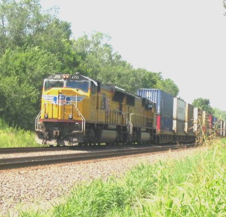Shot of UP Power on stack train stopped at signal, 8-16-05